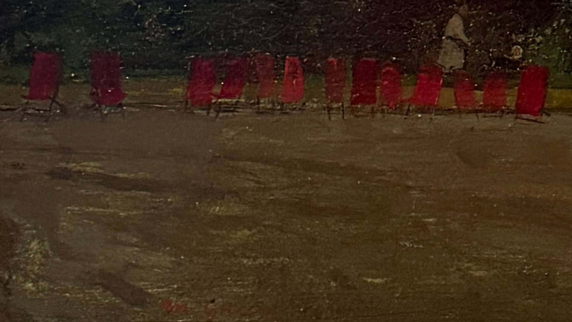 Oil painting of red chairs lined up outdoors at night